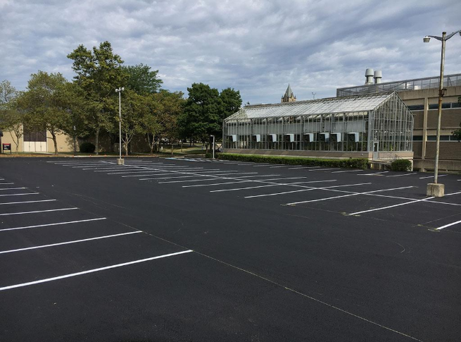 “Freshly resurfaced parking lot with clean black asphalt and bright white striping during an asphalt service in Fulshear, TX”