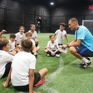 Soccer coach talking to a group of young boys for Space Coast United Soccer