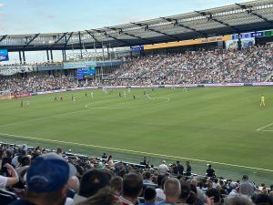 Soccer game in a packed stadium]
