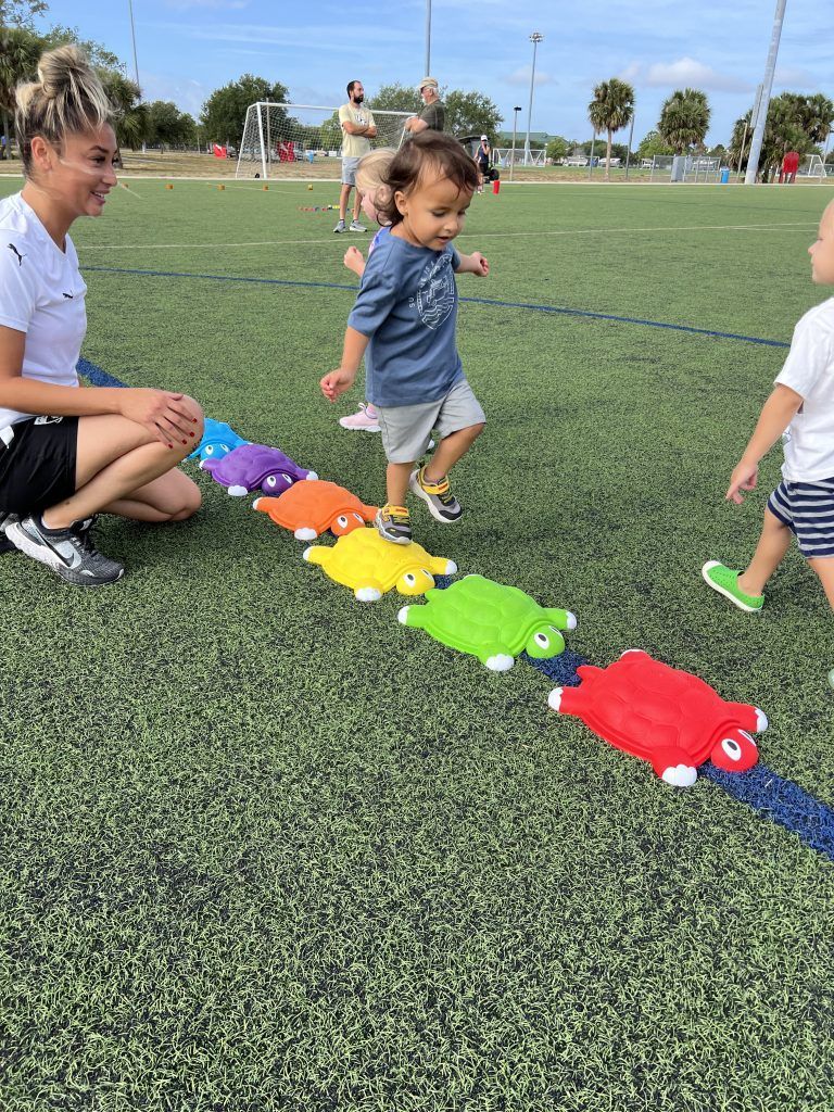 Children playing in the Space Coast United Soccer Tiny Toes program