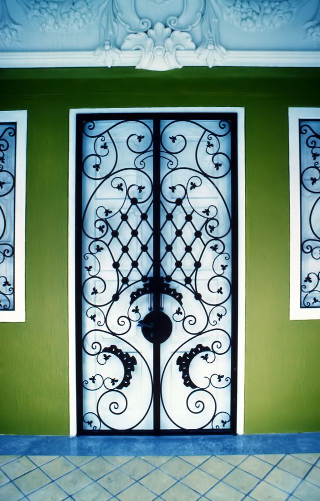 Black Metal Gate With Intricate Scrollwork — Australian Flyscreens & Security Doors in Morisset, NSW