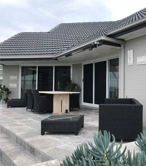 Modern Patio With Dark Wicker Furniture — Australian Flyscreens & Security Doors in Cameron Park, NSW