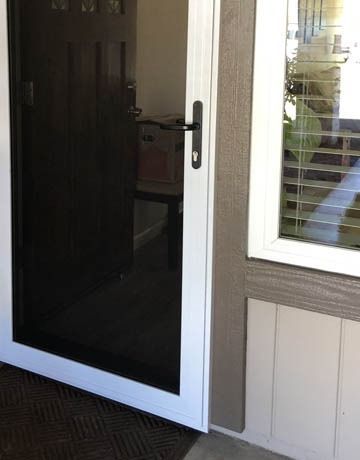White Storm Door With a Black Handle — Australian Flyscreens & Security Doors in Morisset, NSW