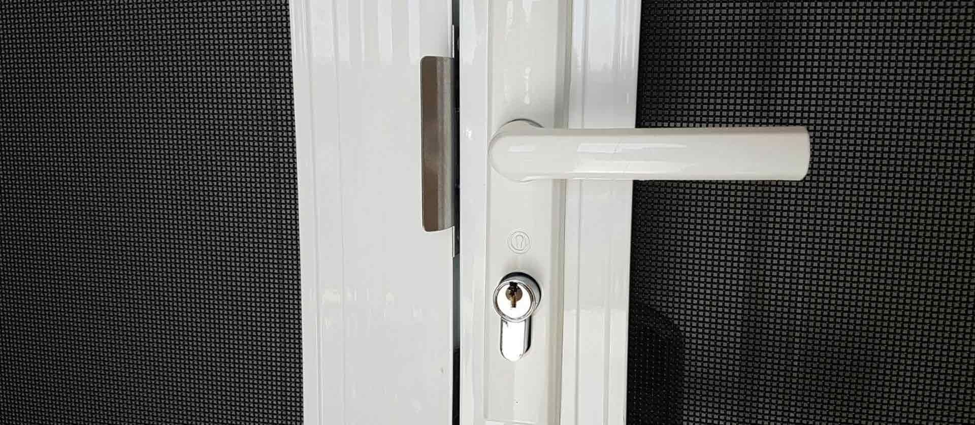 White Door Handle and Locking Mechanism Mounted — Australian Flyscreens & Security Doors in Toronto, NSW