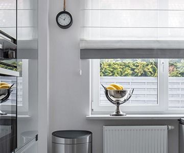 Kitchen Window With White Roman Shades — Australian Flyscreens & Security Doors in Toronto, NSW