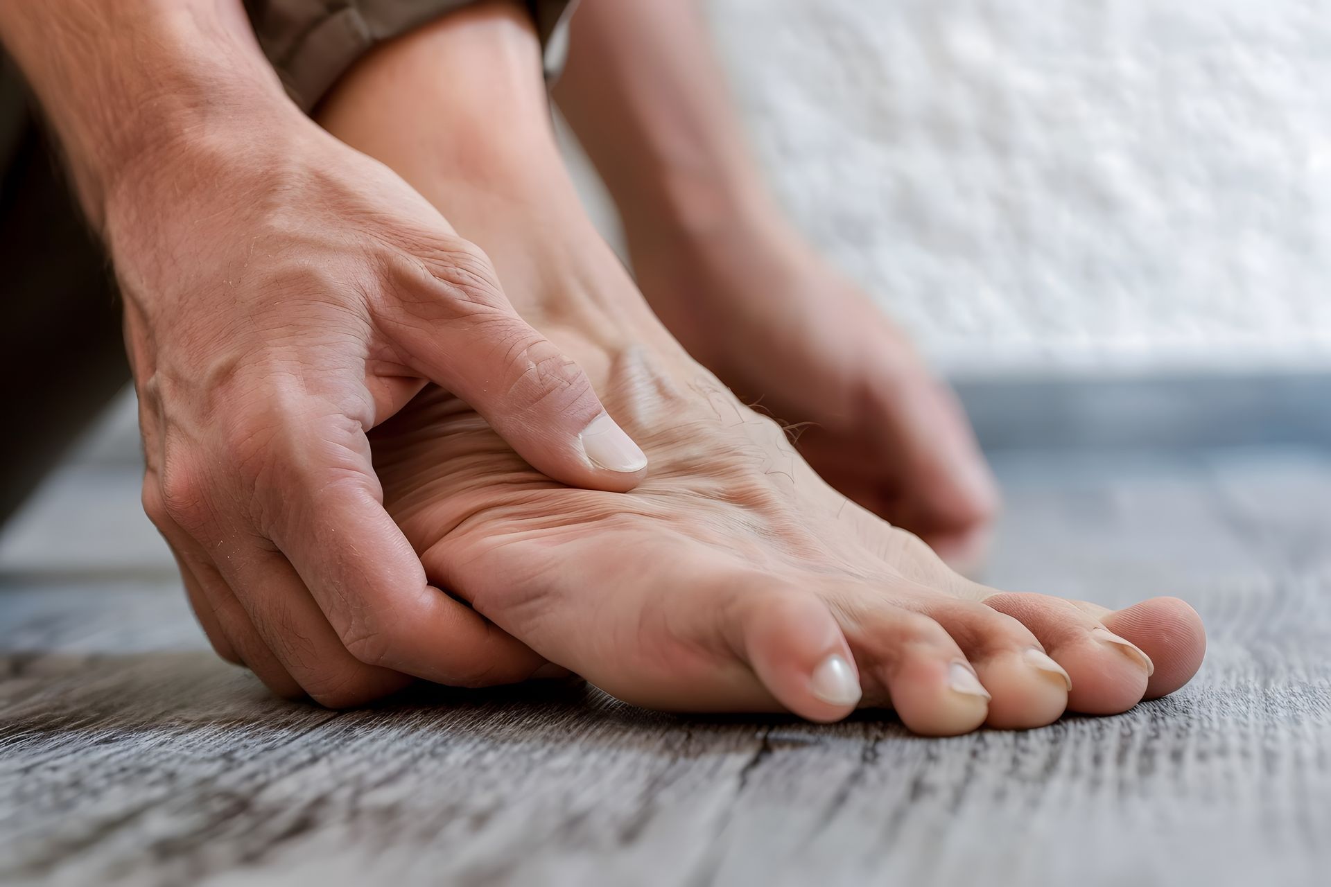 man holding foot in pain