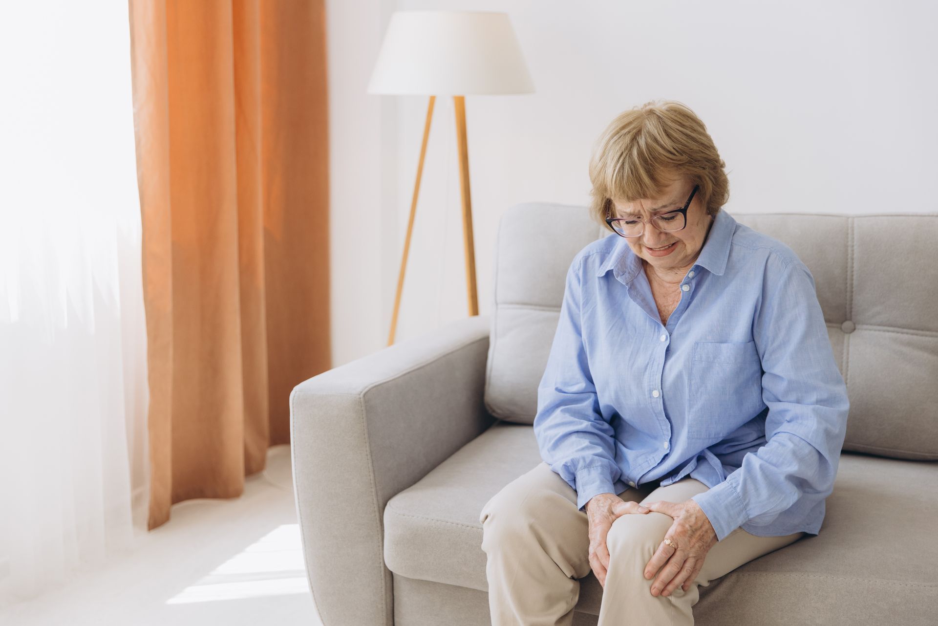 woman holding her knee in pain