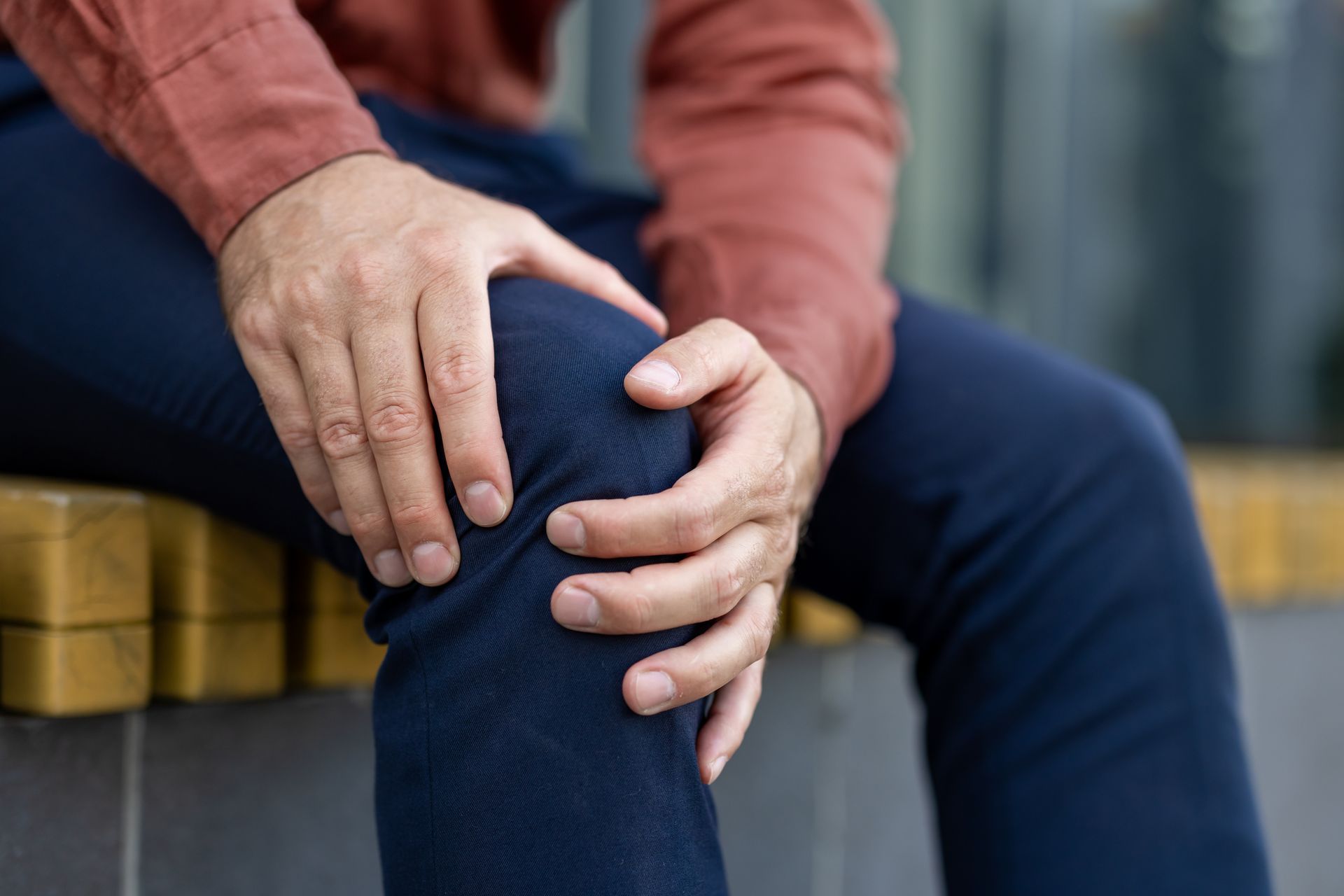 man holding his knee in pain