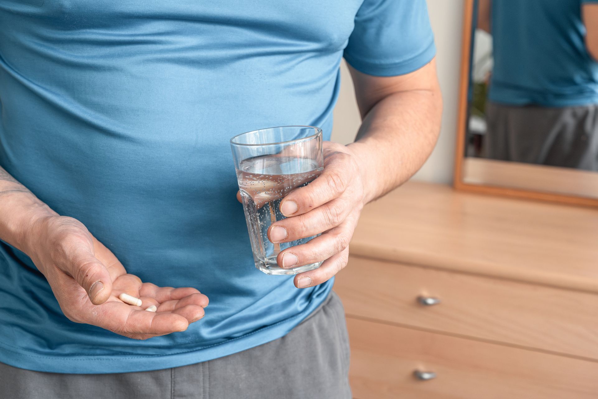 man taking oral supplements