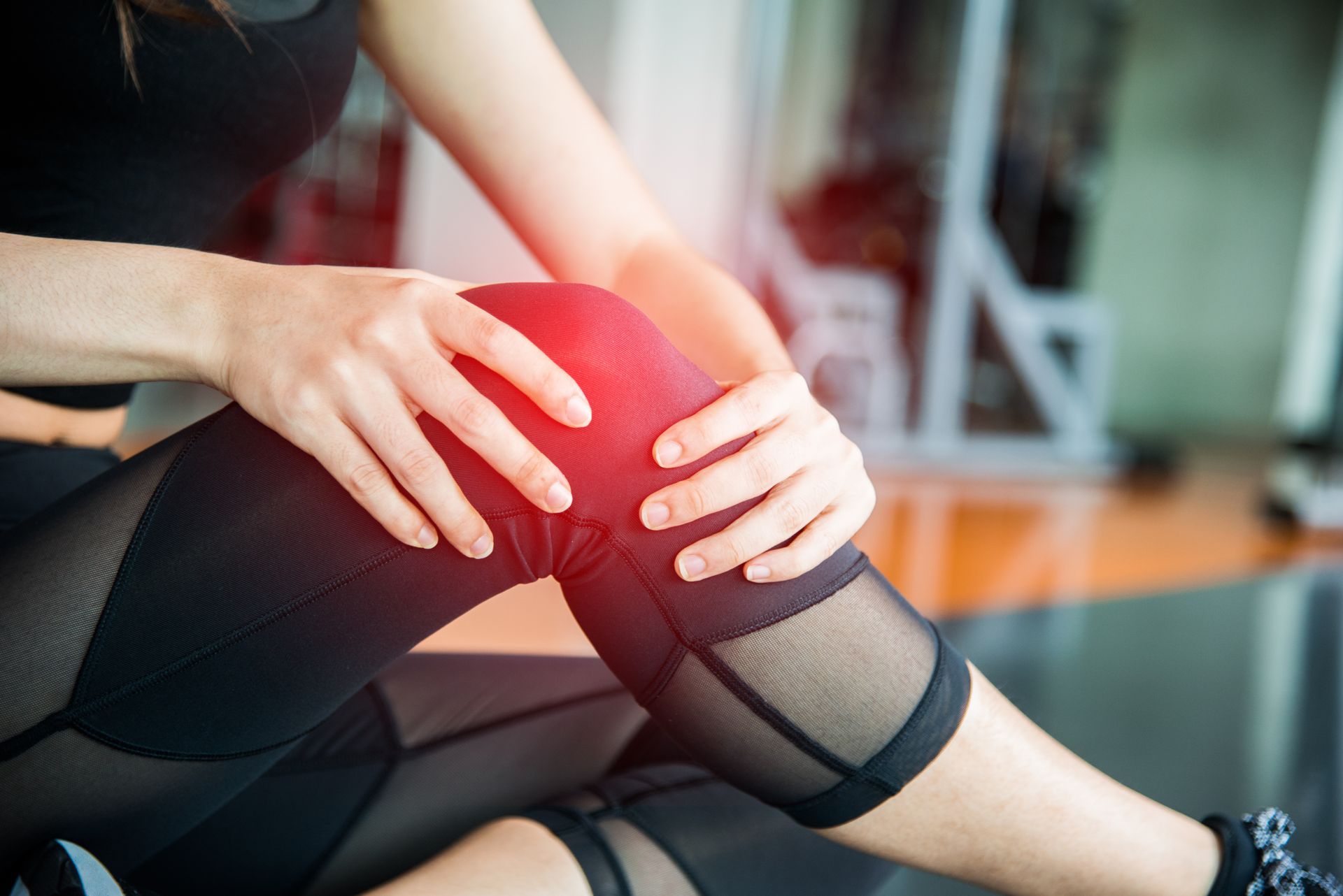 woman holding knee in pain