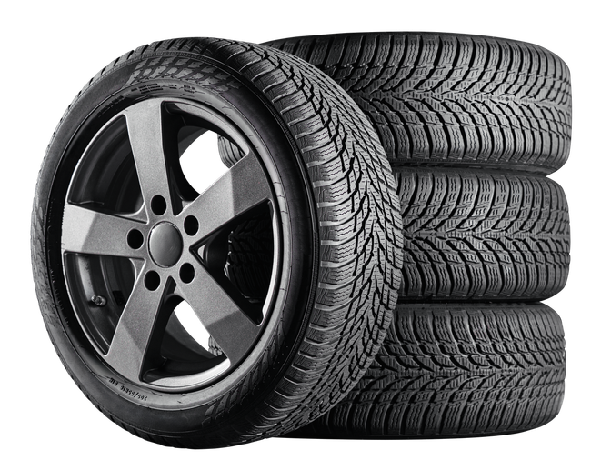 Stack of black tires with a silver alloy wheel in front, isolated on a white background