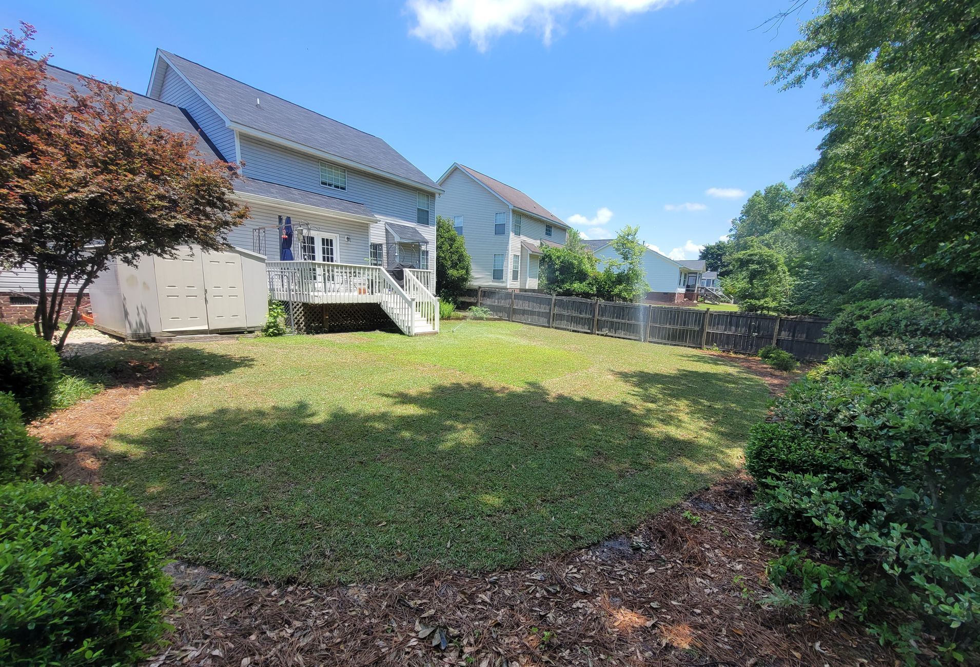 house exterior with custom landscape and hardscape