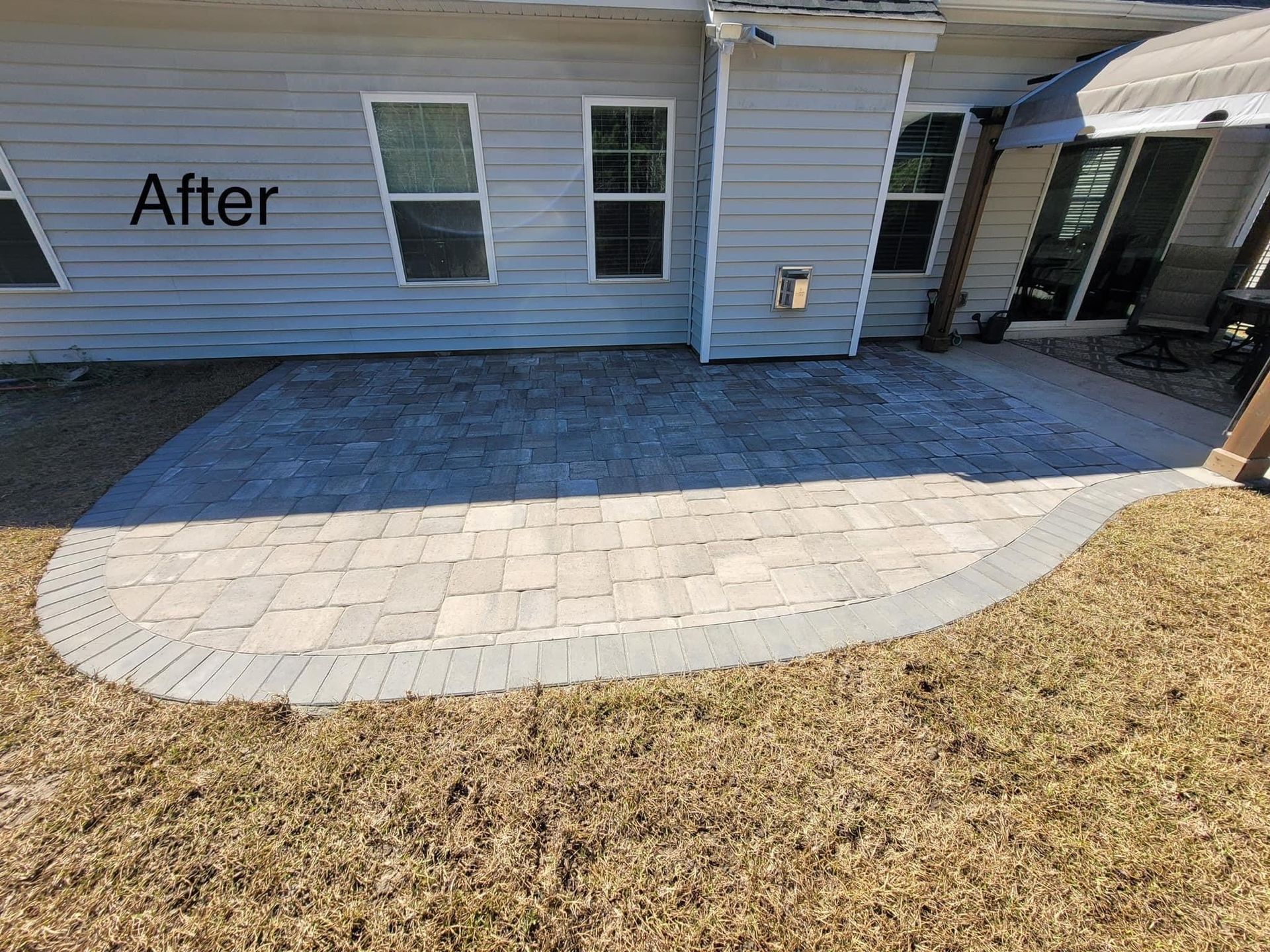 exterior view of a residential home renovated with custom concrete patio