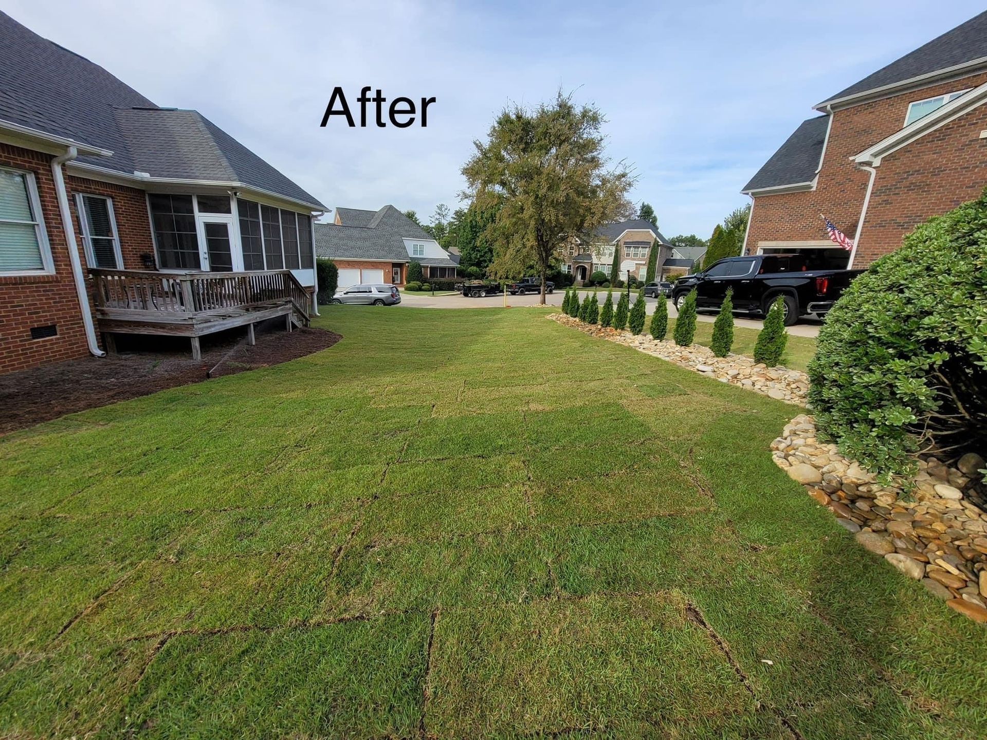 house exterior with custom landscape and hardscape