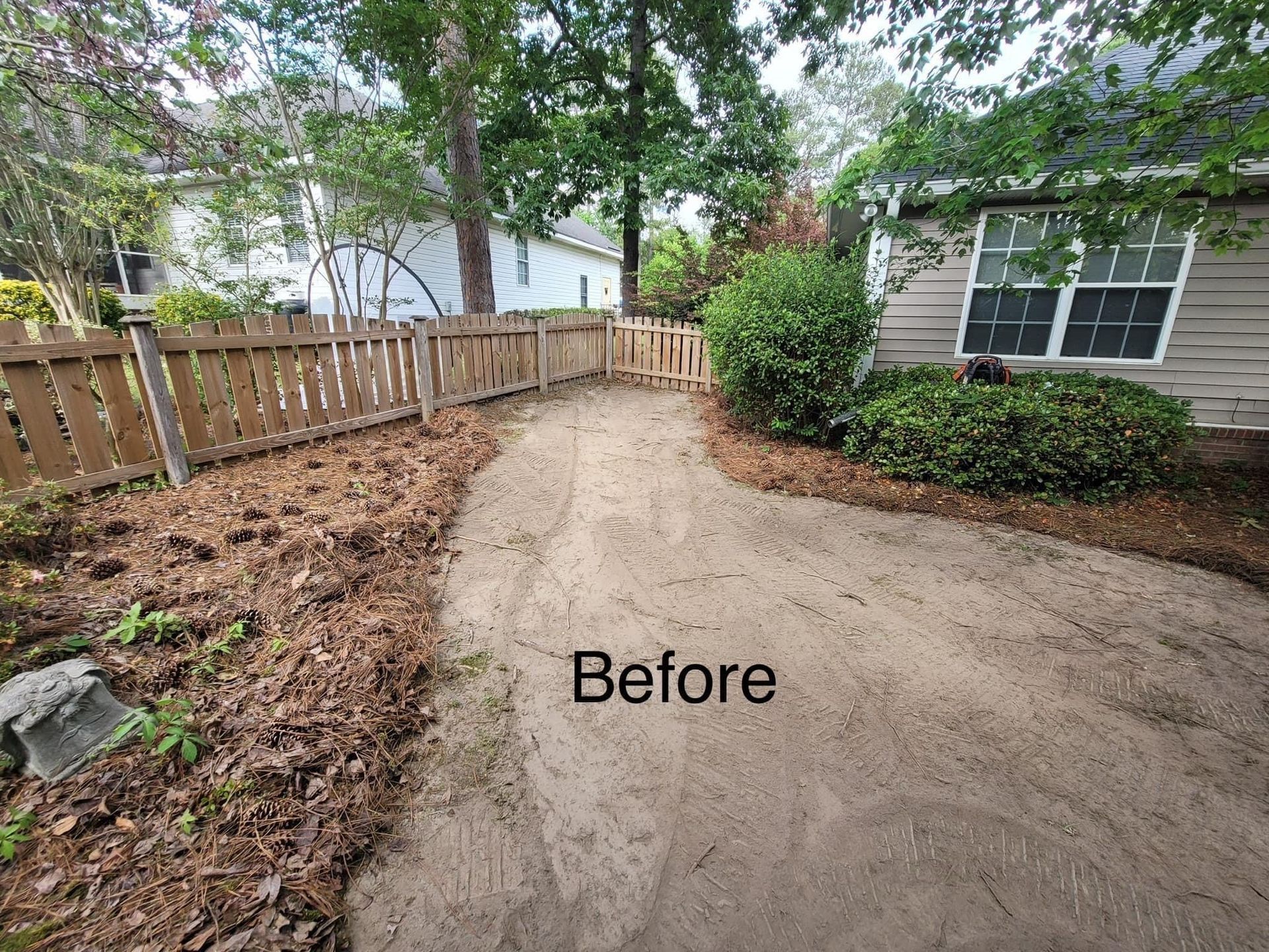 before image of a house backyard with wooden fence