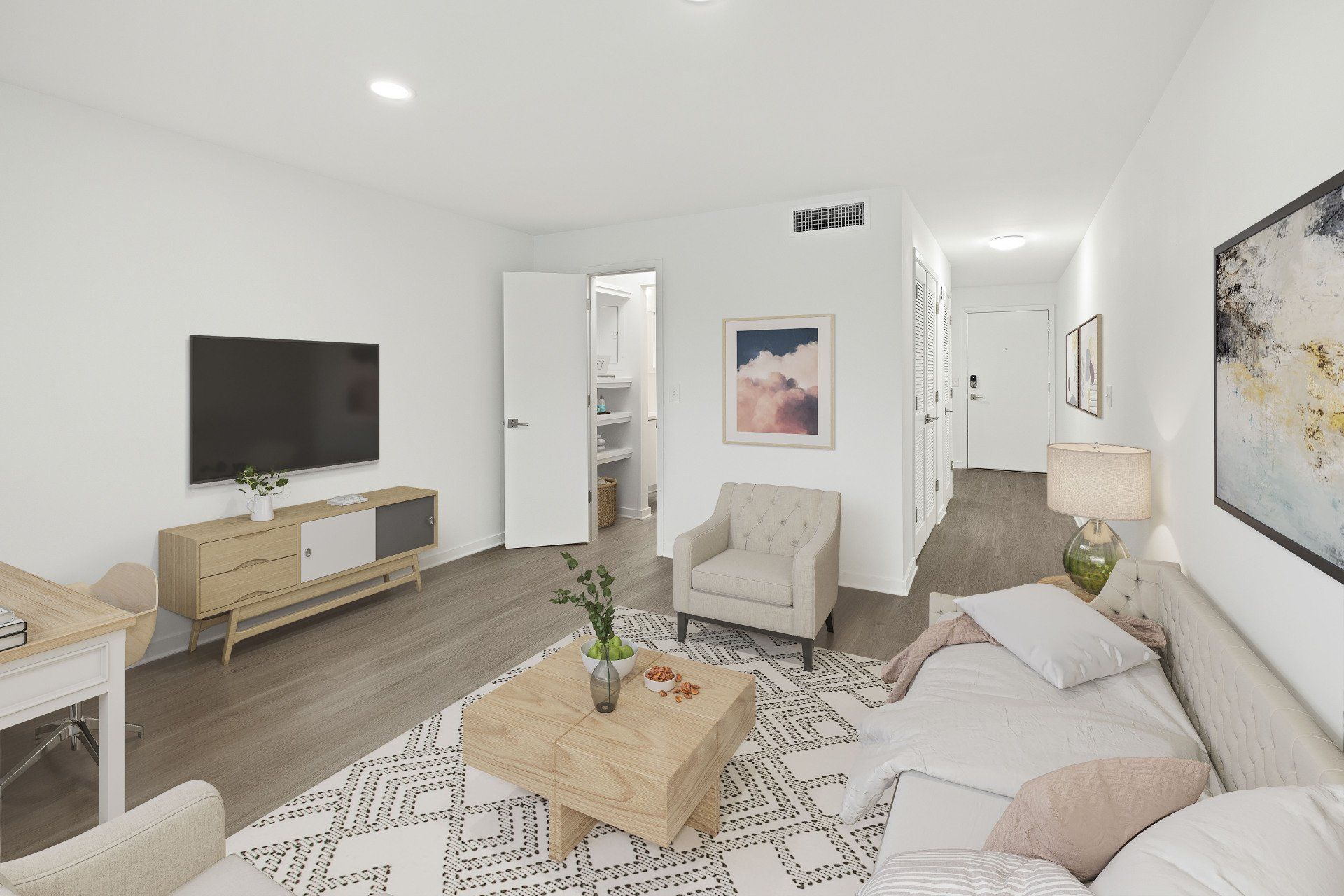 A living room with a couch , chair , coffee table and television.
