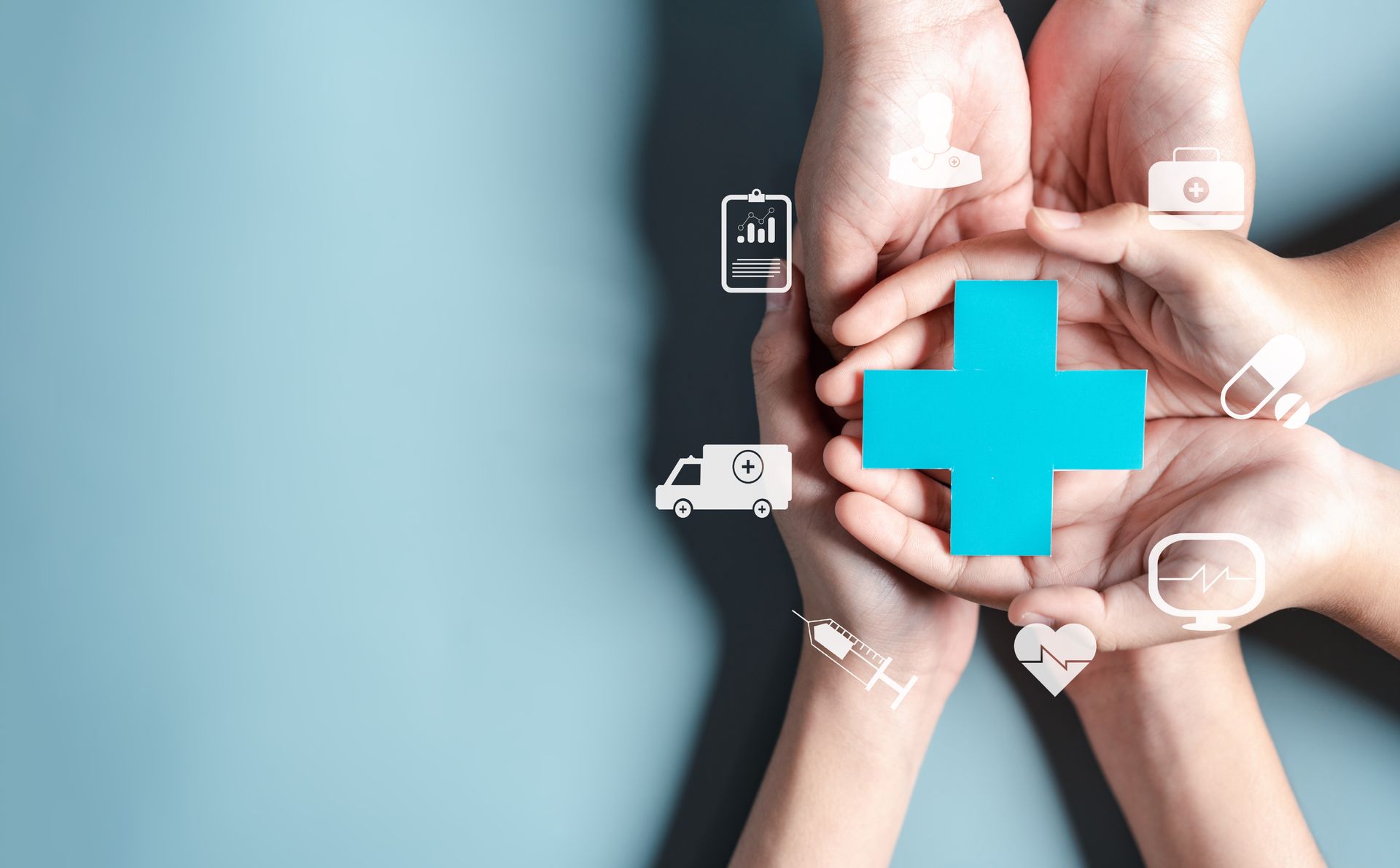 Hands holding a blue medical cross with health icons on a light background