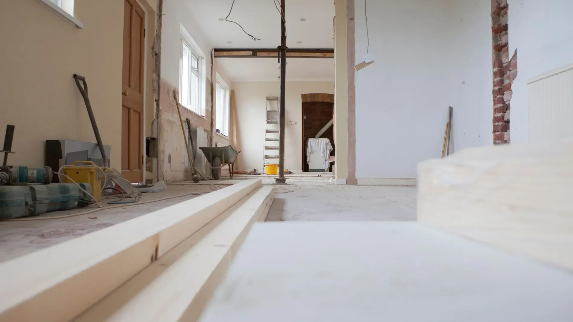 A room that is being remodeled with wooden boards on the floor.