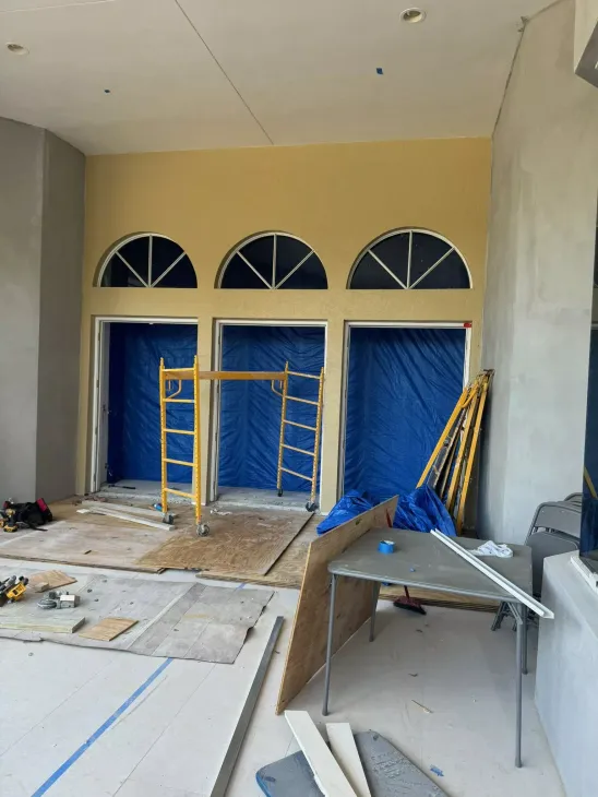 A room under construction with a table and scaffolding