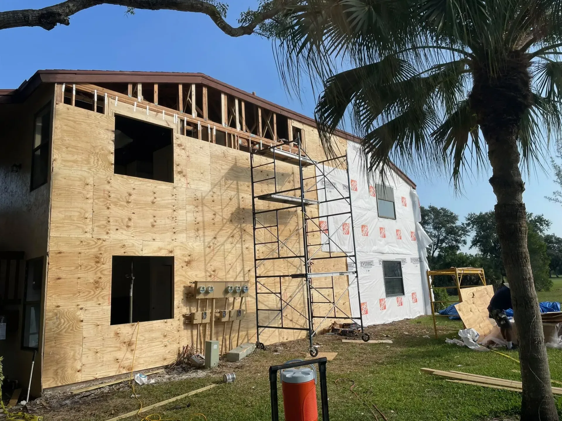 A house that is being built with a cooler in front of it