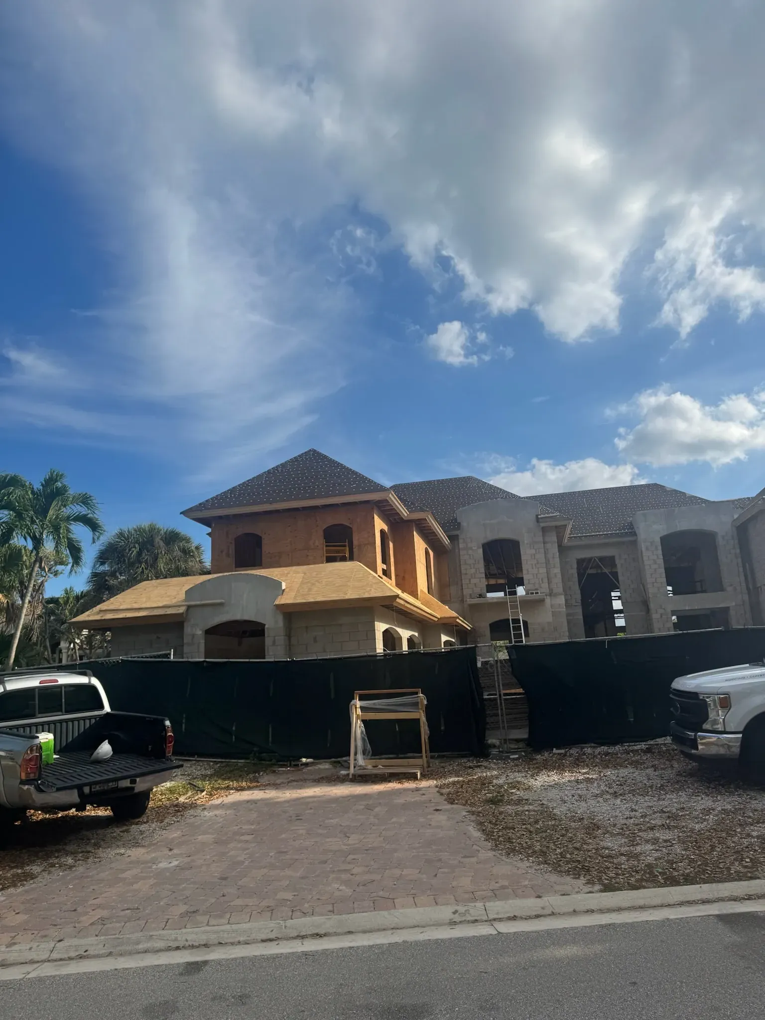 A large house under construction with a truck parked in front of it.
