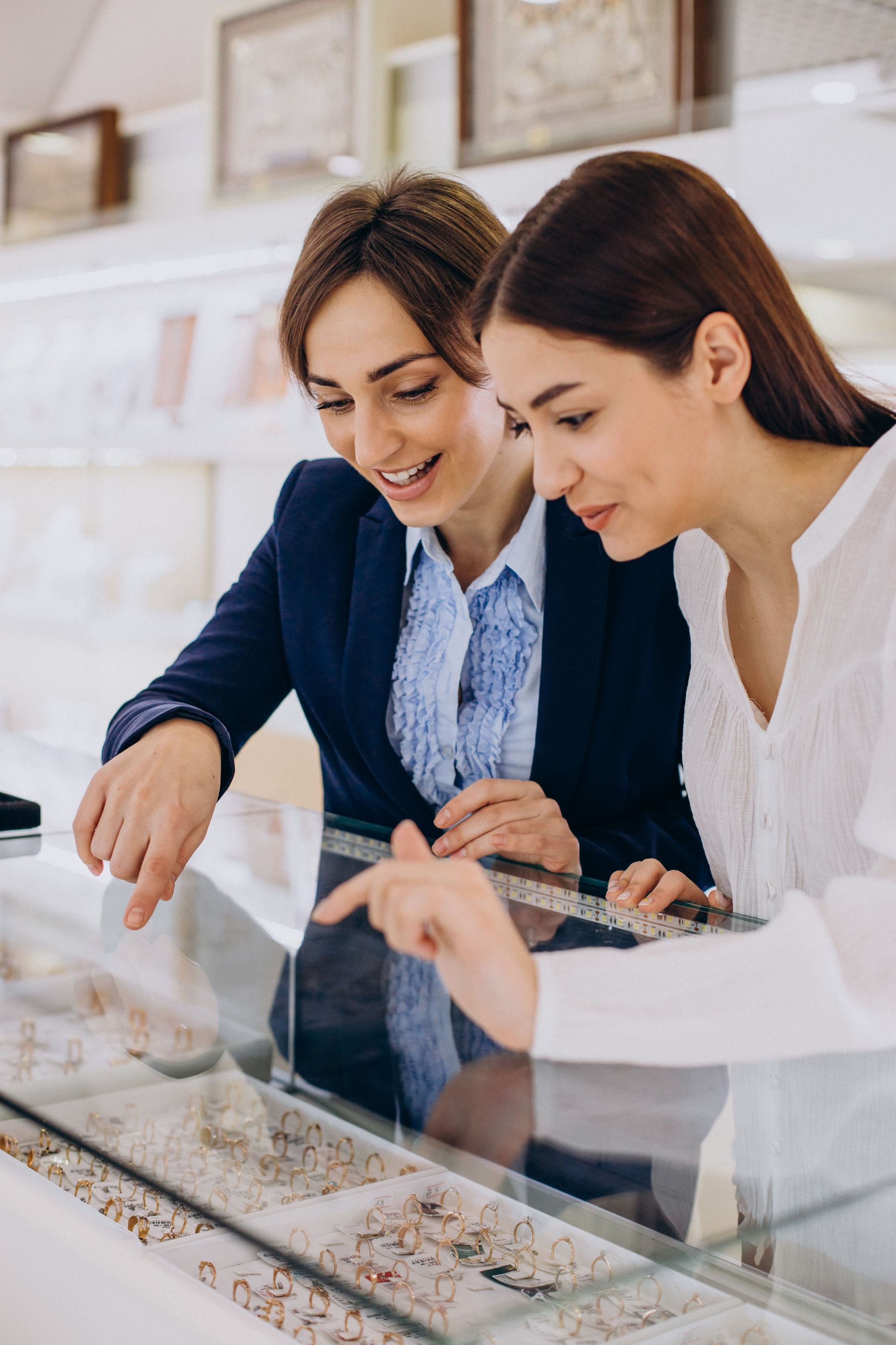 consultant helping customer to choose a wedding ring