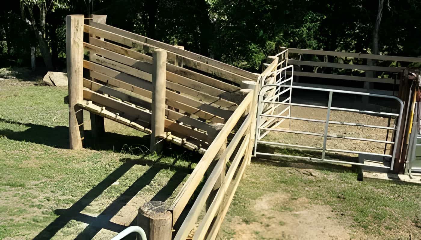 A Wooden Fence is Sitting in the Middle of a Grassy Field — Osborne Fencing in Bundanoon, NSW