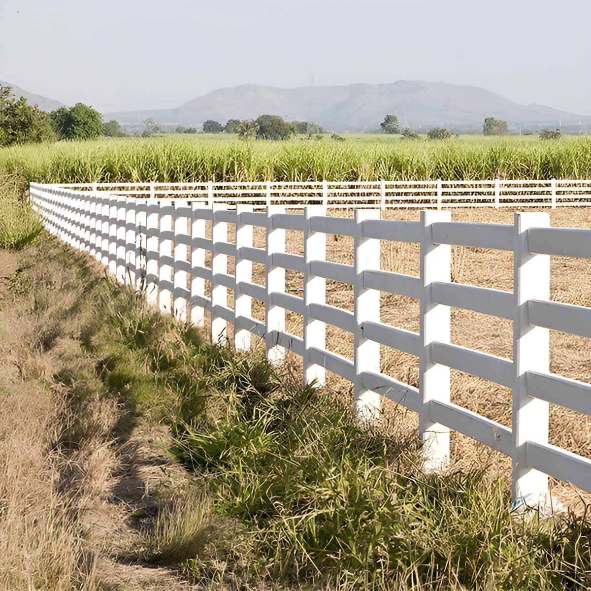 A White Fence Surrounds a Field With Mountains — Osborne Fencing in Bundanoon, NSW