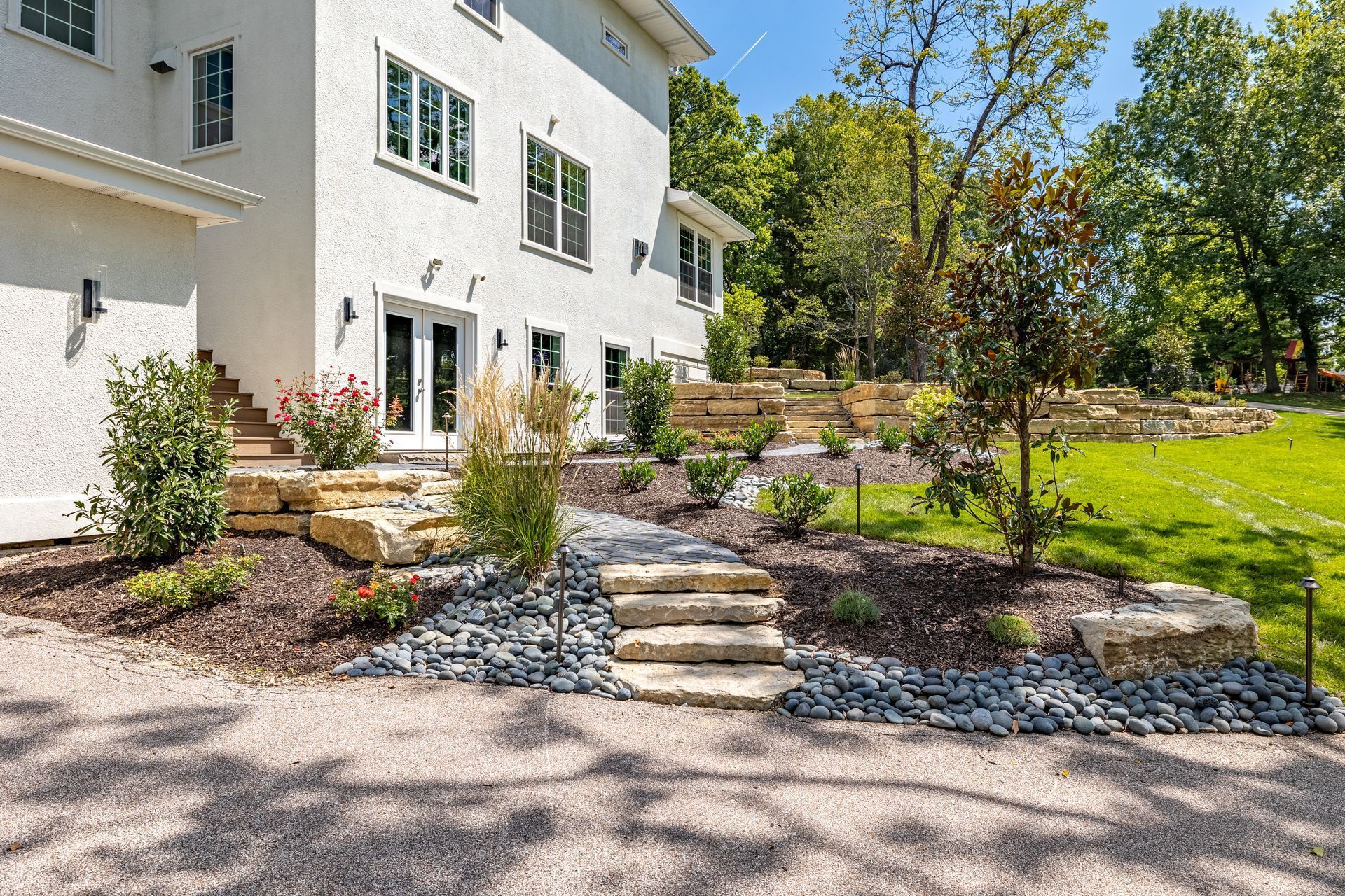 A large white house with stairs leading up to the front door.
