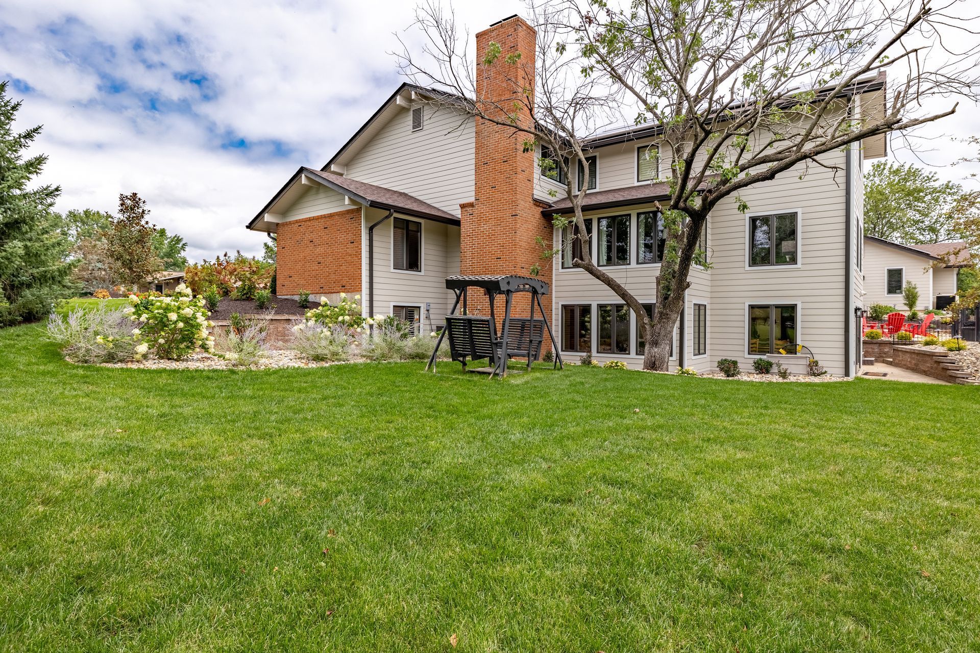 A large house with a large lawn in front of it.