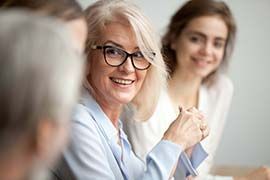 a woman is sitting in a gynecological chair talking to a doctor .