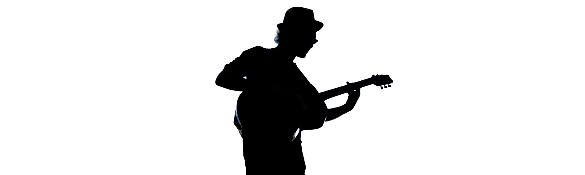 Silouhette d'une jeune homme jouant de la guitare acoustique.