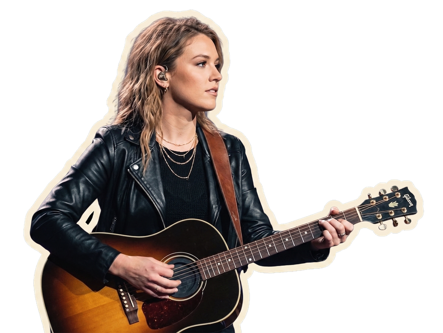 Musician in black jacket playing acoustic guitar on a white background