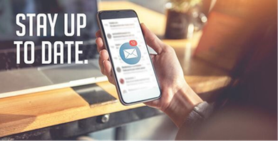 Hand holding a smartphone with email alert icon beside the text “STAY UP TO DATE.”