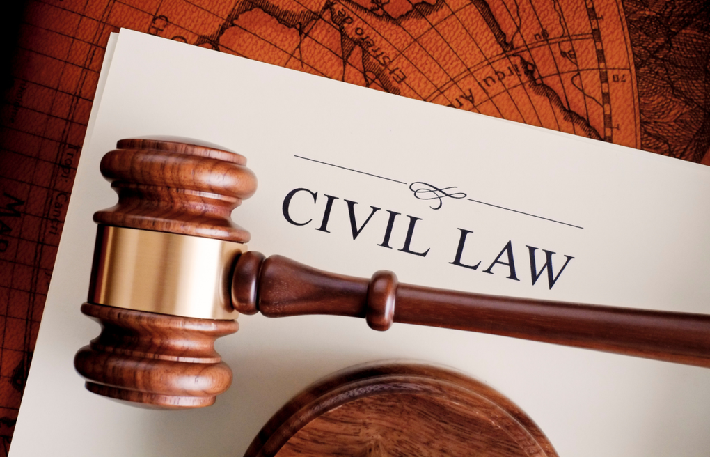 Judge’s gavel over a document labeled “CIVIL LAW” on a warm-toned legal background