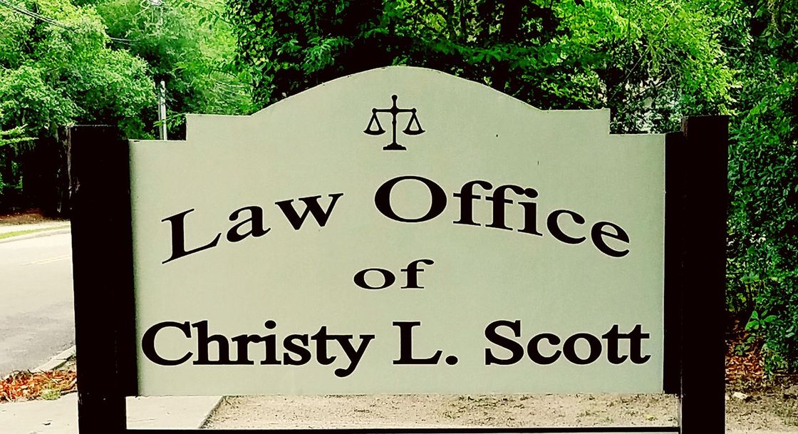 Sign for Law Office of Christy L. Scott with scales of justice logo
