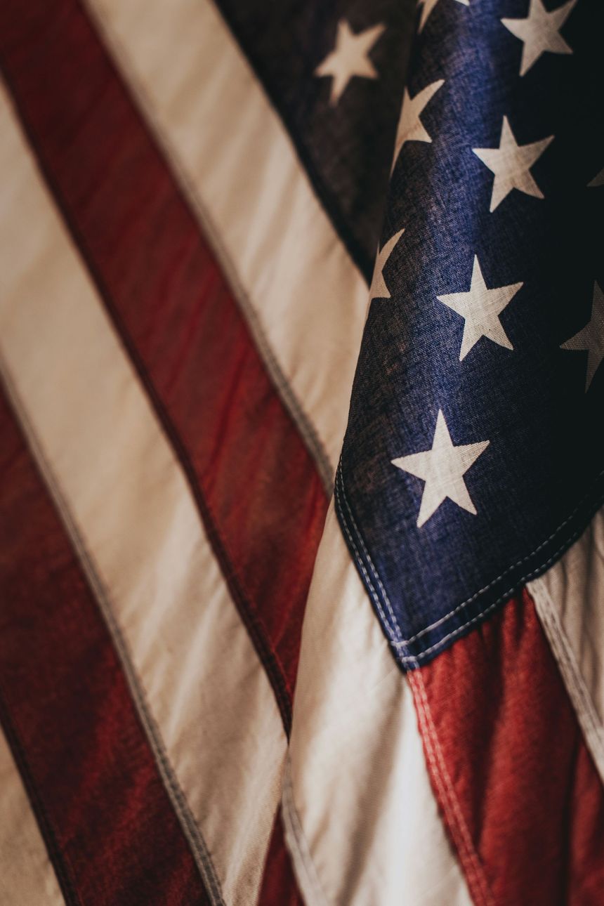 Close-up of a folded American flag with red, white, and blue stars and stripes.