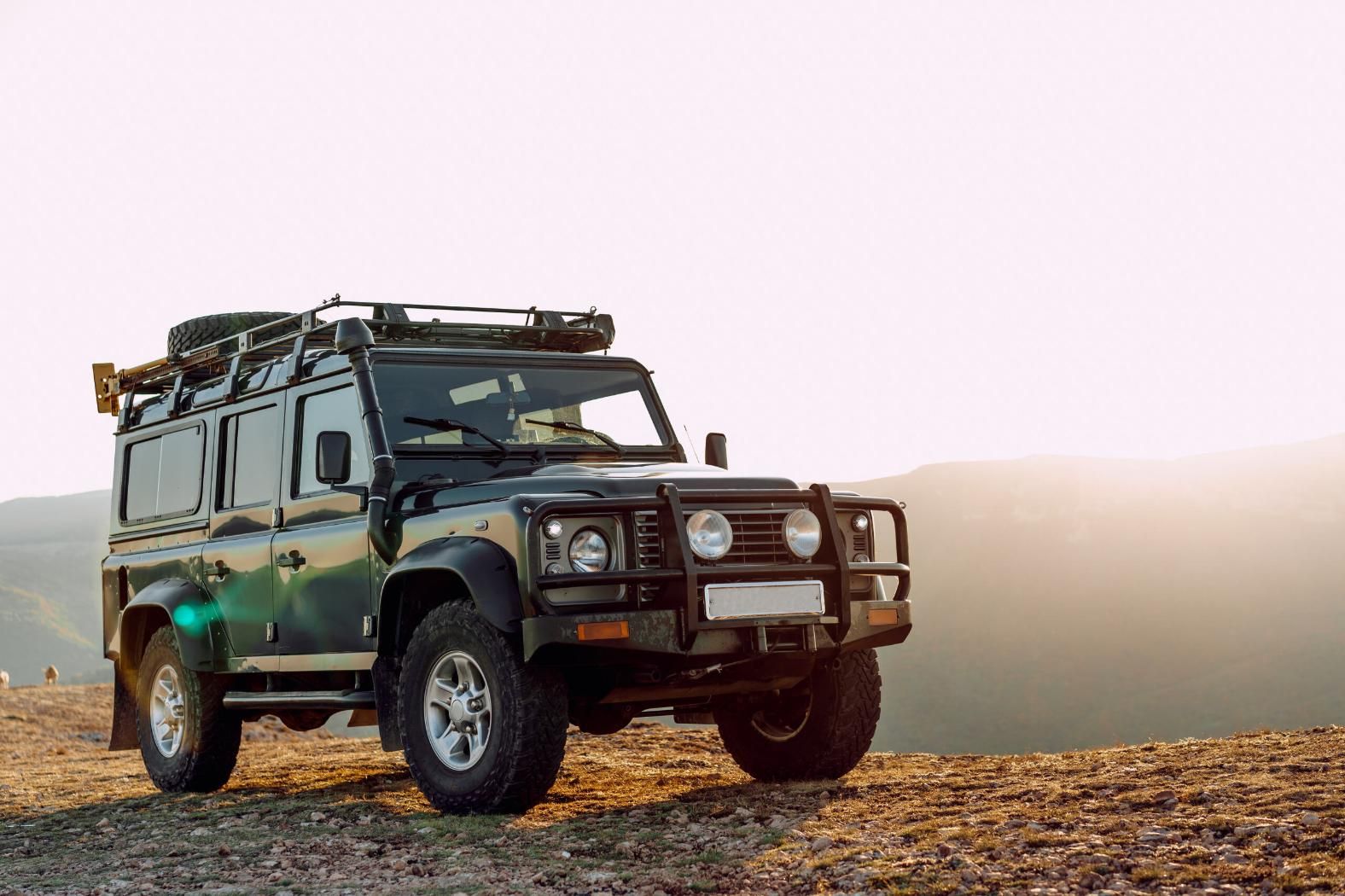 A Green Jeep is Parked on Top of a Dirt Hill — Land Rover Spares In Mackay, QLD