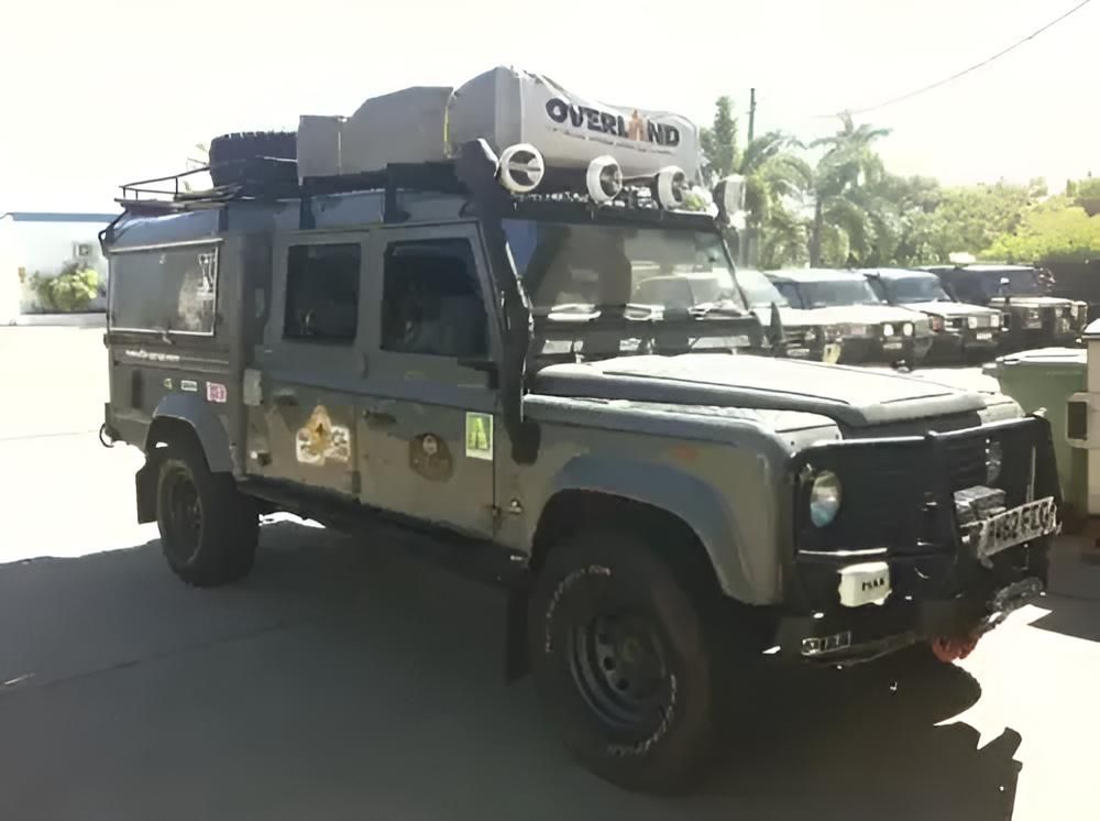 A Gray Overland Truck is Parked in a Parking Lot — Land Rover Spares In Mackay, QLD