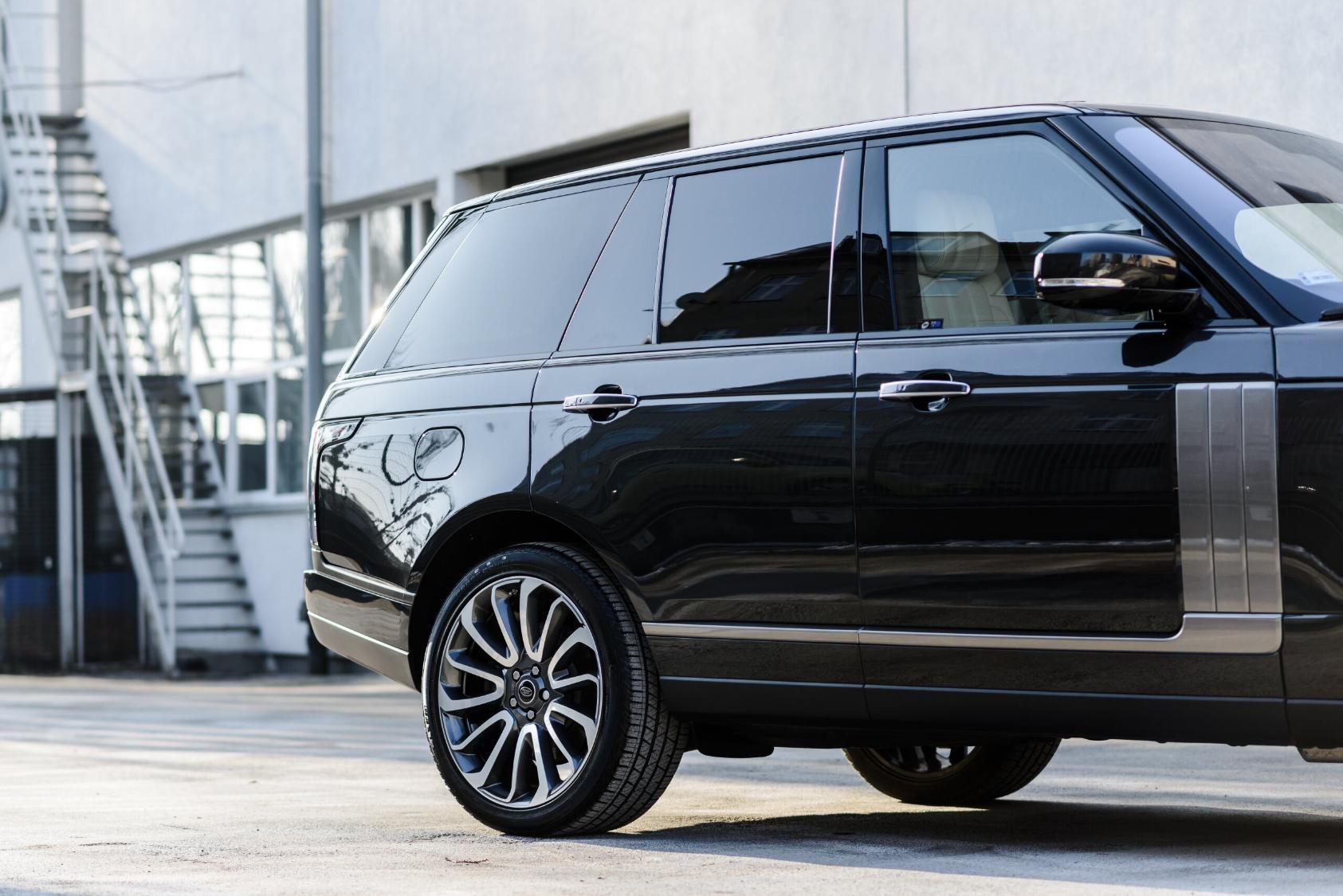 A Black Range Rover is Parked in a Parking Lot in Front of a Building — Land Rover Spares In Mackay, QLD