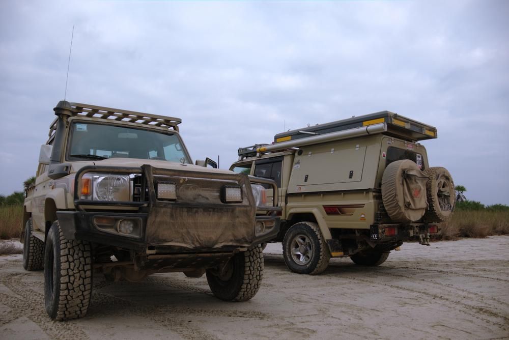 Two Trucks Are Parked Next to Each Other on a Dirt Road — Land Rover Spares In Mackay, QLD