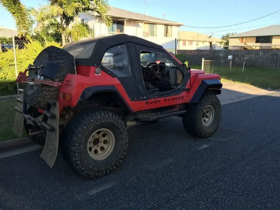 A Red Buggy is Parked on the Side of the Road — Land Rover Spares In Mackay, QLD