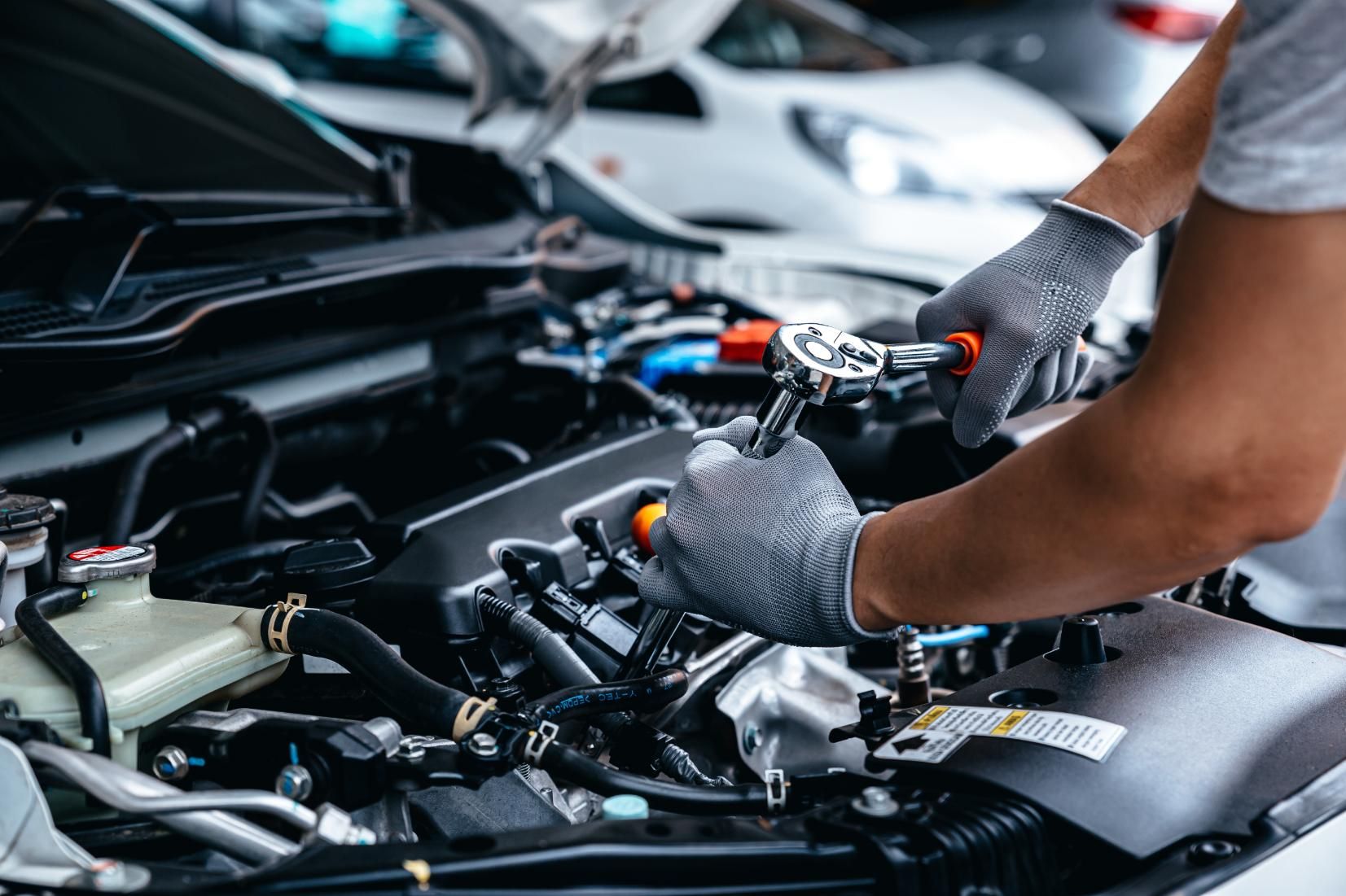 A Man is Working on the Engine of a Car — Land Rover Spares In Mackay, QLD