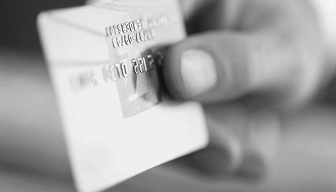 A person is holding a credit card in their hand.