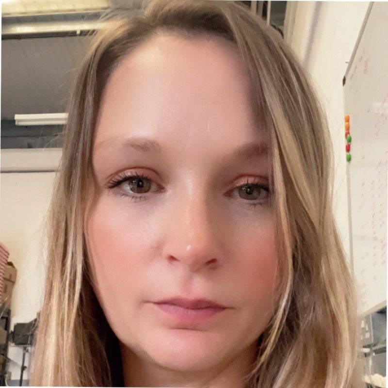 A close up of a woman 's face with long blonde hair