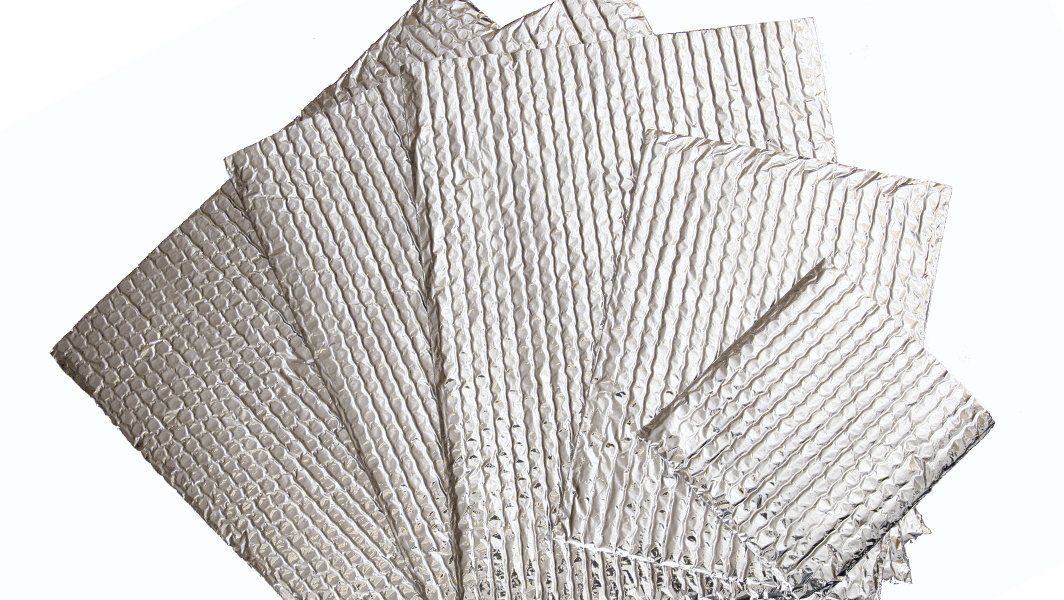 A bunch of white napkins are stacked on top of each other on a white background.
