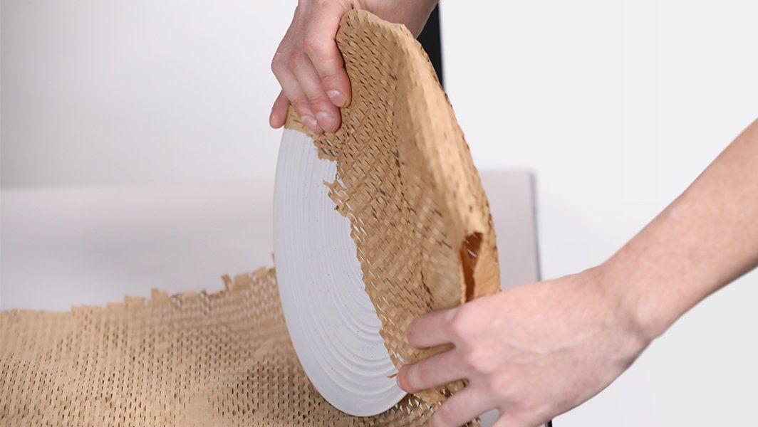A person is holding a piece of wood in their hands.