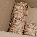 A close up of a cardboard box filled with shredded paper.