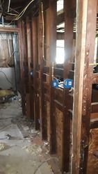 A room with a lot of wooden walls and a window.