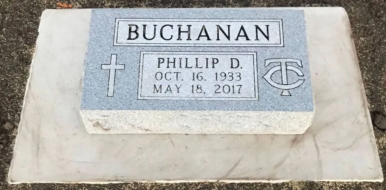 Gravestone with “BUCHANAN” and “PHILLIP D.” inscription, with cross and Christian symbol.